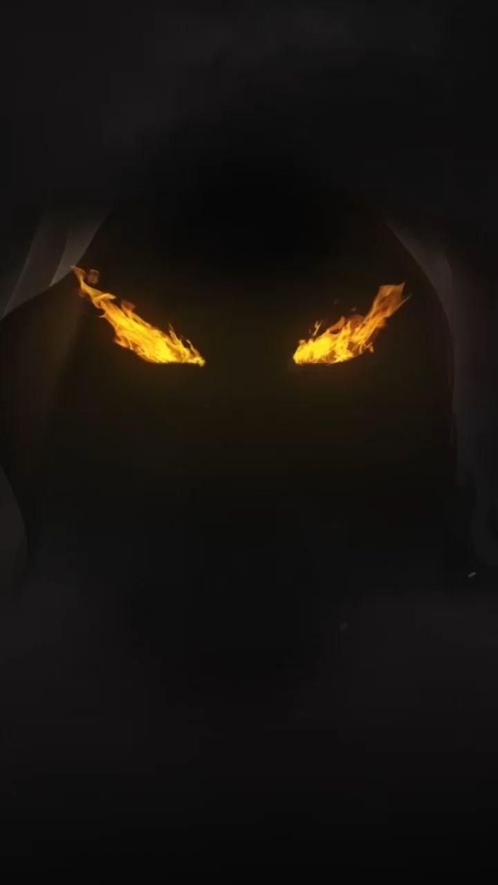 the eyes of an animal with yellow flames on it's face are glowing in the dark