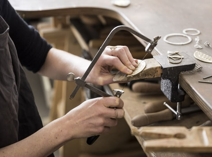 a person working with wood and metal tools