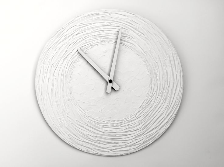 a white clock that is on the wall