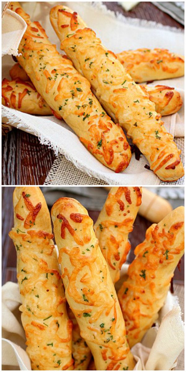 bread sticks with cheese and herbs on them