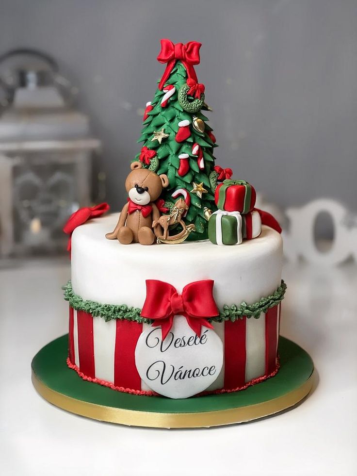 a decorated christmas cake with a teddy bear on top