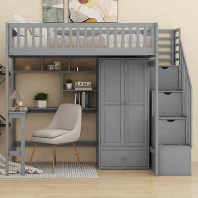 a loft bed with stairs and desk underneath