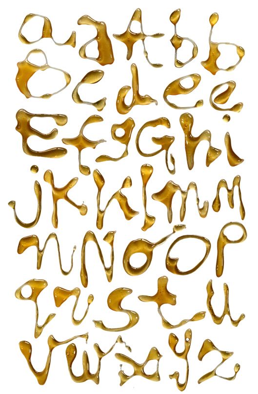 the letters are made out of gold paint and have different shapes, sizes, and colors