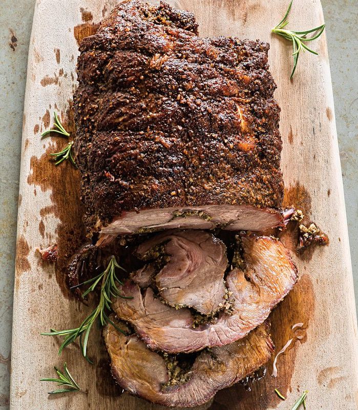 a large piece of meat sitting on top of a wooden cutting board