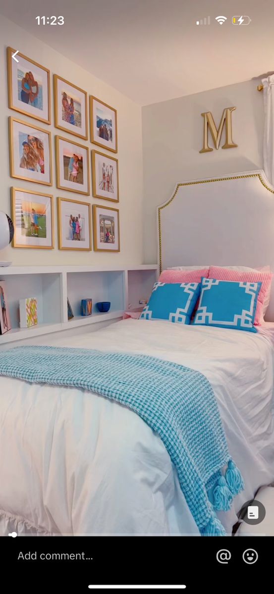 a bedroom with pictures on the wall above the bed and below the bed is a white headboard