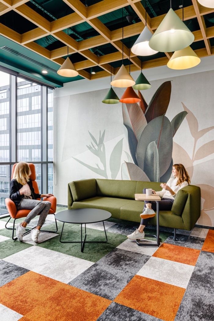 two women are sitting in chairs and talking