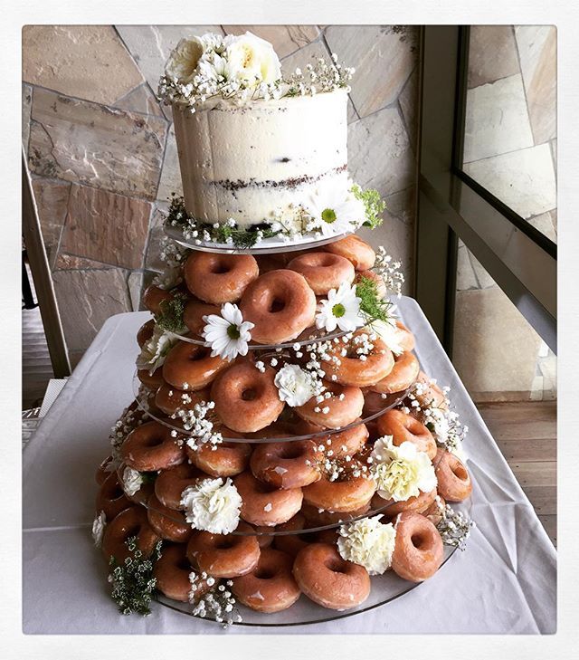 a wedding cake made out of donuts and flowers