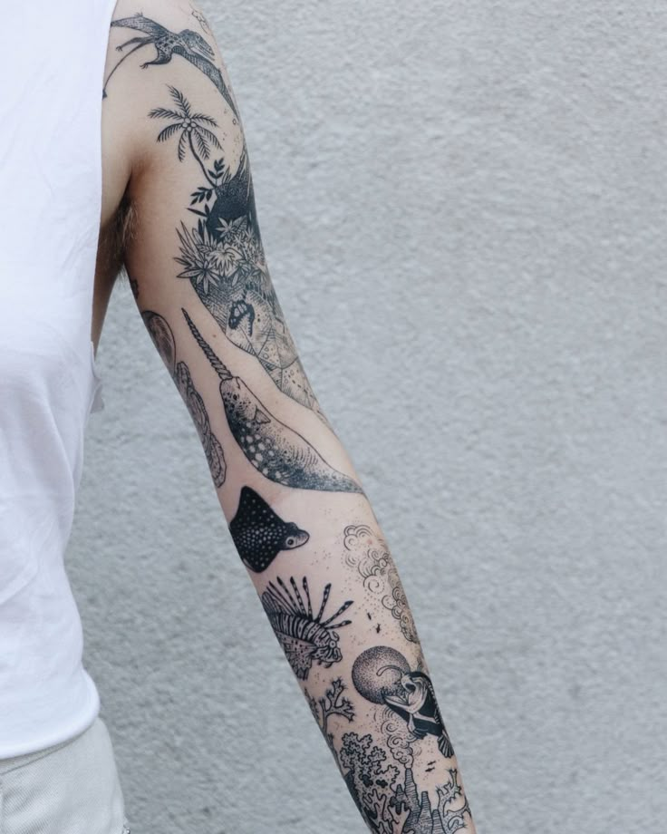 a man's arm with tattoos on it and an image of animals in the background