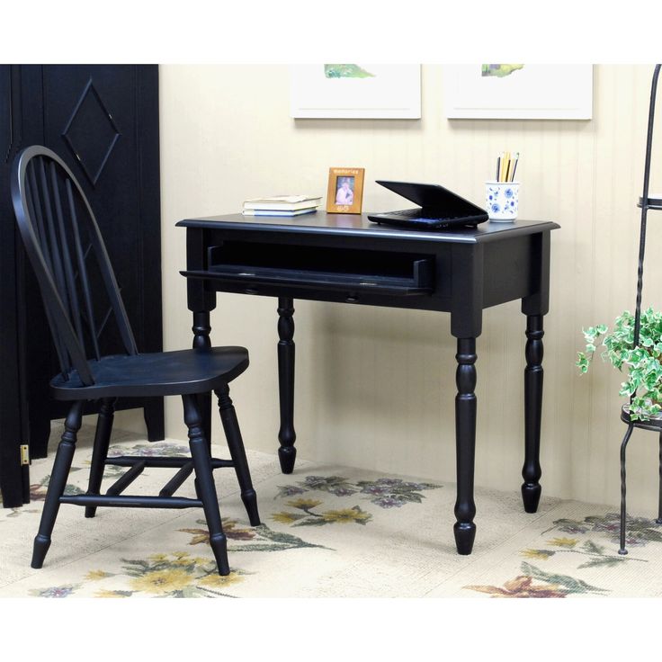 a black desk with a chair next to it