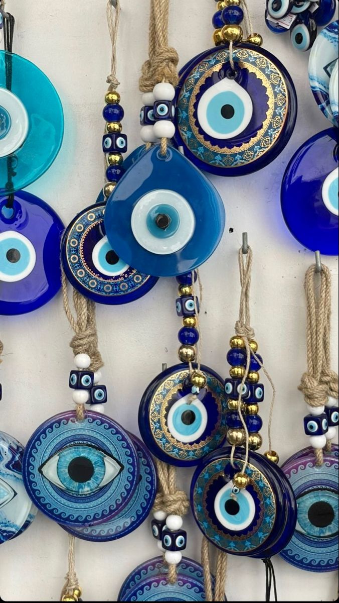 evil eye glass ornaments are hanging on the wall