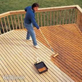 a man with a mop is cleaning the deck