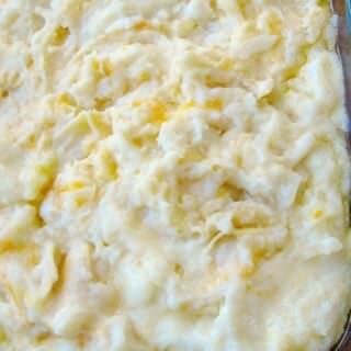 a casserole dish filled with mashed potatoes