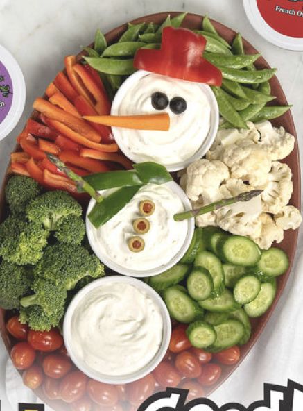 a snowman made out of vegetables and dips on a plate with the words good food written below it