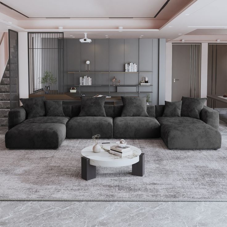 a modern living room with grey couches and white coffee table in the center area