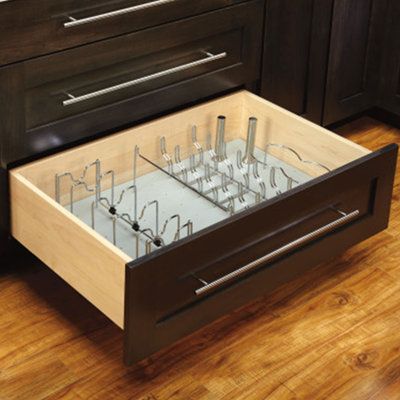 an open drawer in the middle of a kitchen