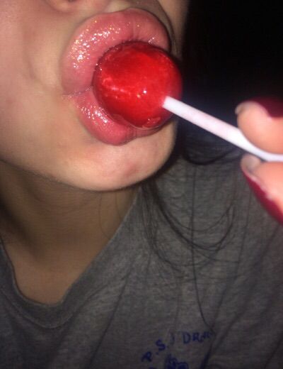 a woman with her tongue sticking out and holding a toothbrush