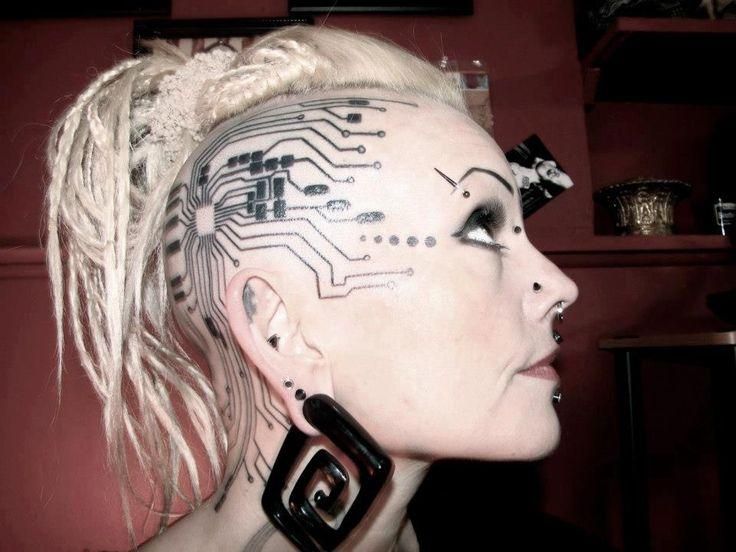 a woman's head with electronic circuit printed on it and hair in pigtails