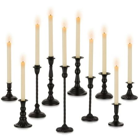 twelve candles are lined up in rows with one candle lit and the other turned off