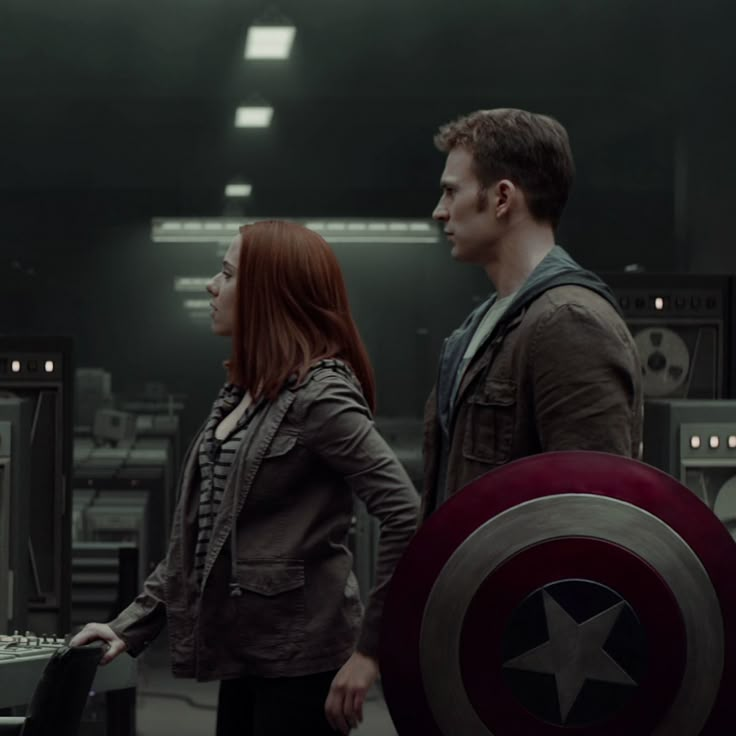 captain america the winter soldier is standing next to a woman