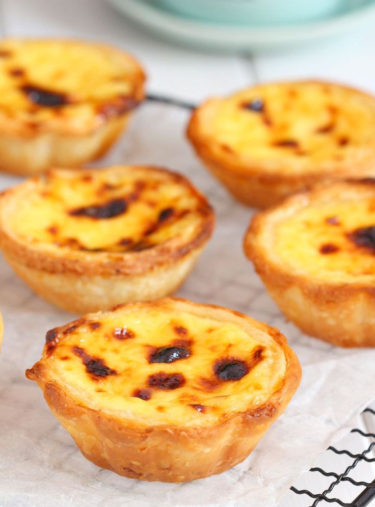 mini quiche pies sitting on top of a cooling rack