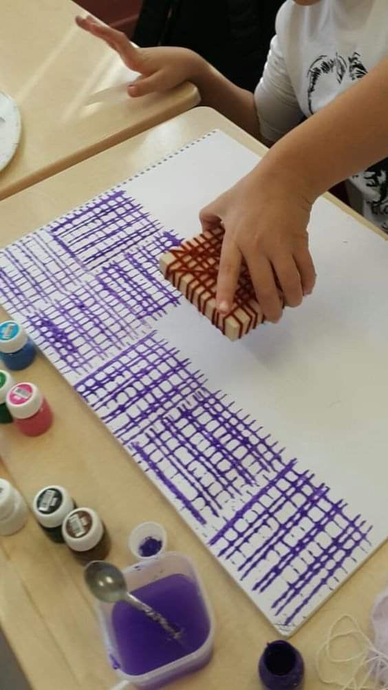 a young boy is working on his art project