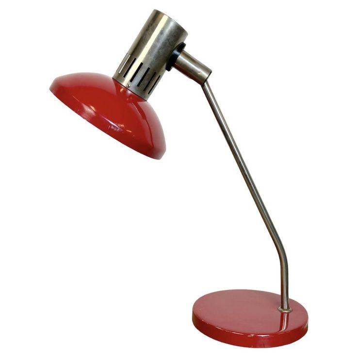 a red desk lamp on a white background