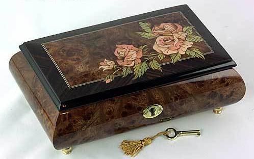 an ornate wooden box with flowers painted on it