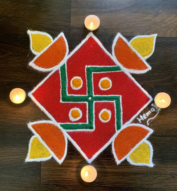 a decorated diya with candles on the floor