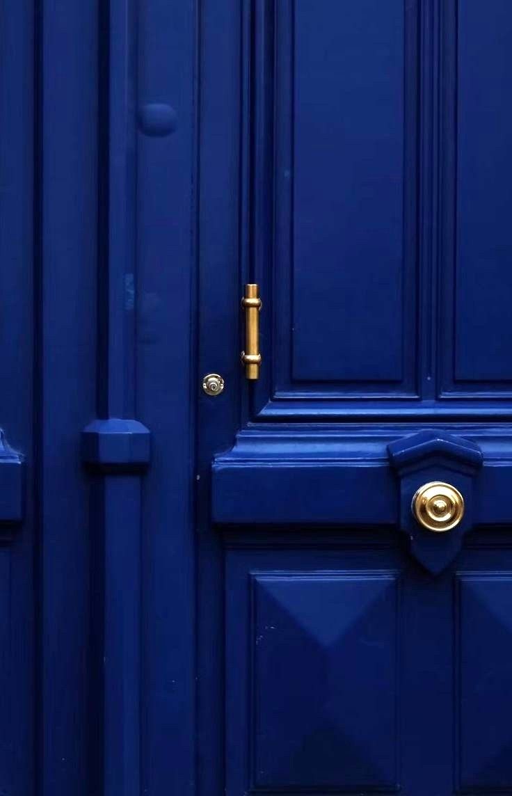 a blue door with a gold handle on it