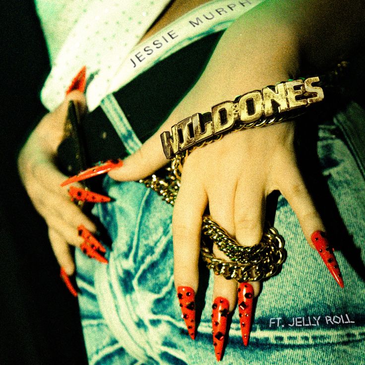 a woman's hand with red nails and bracelets holding onto her wrist that says wild ones