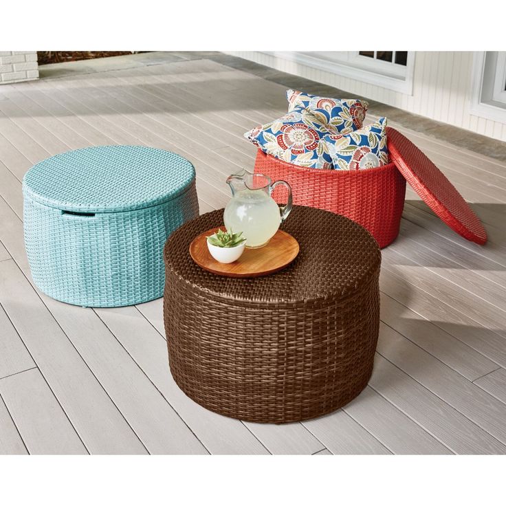 three wicker stools on a deck with plates and cups