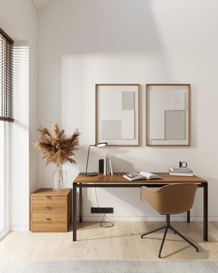 a home office with two framed pictures on the wall and a desk in front of it