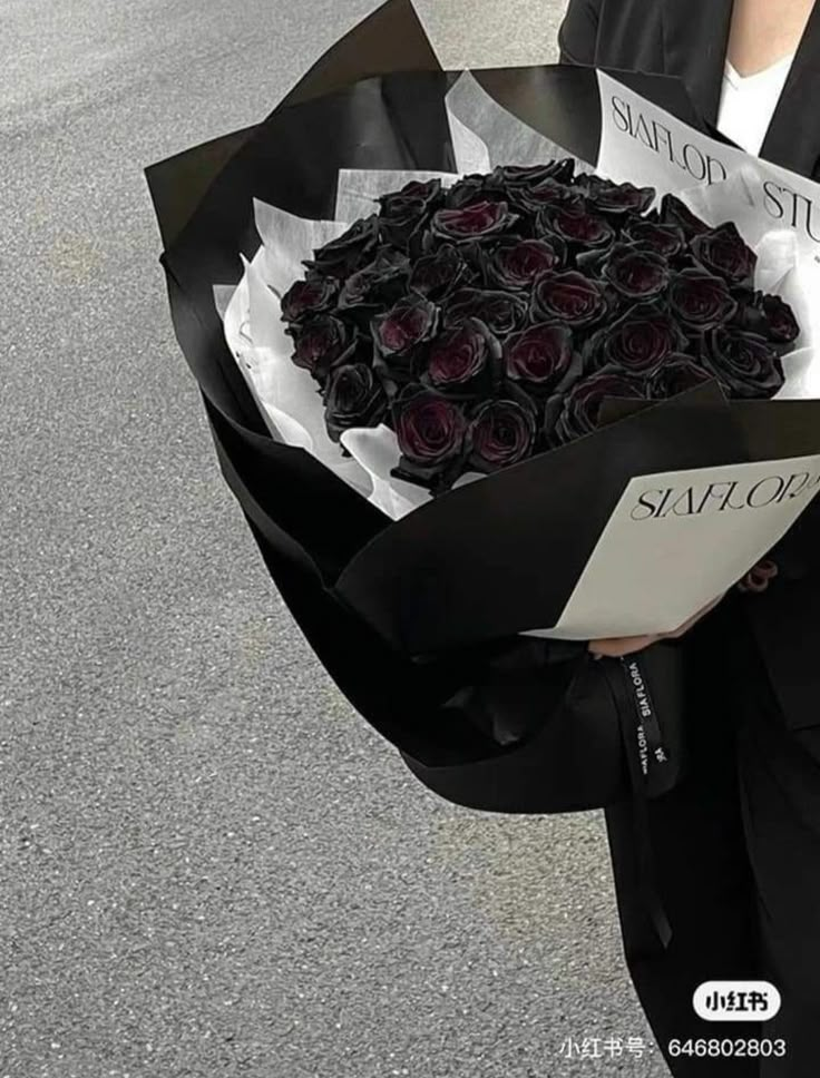 a person holding a bouquet of roses on the street