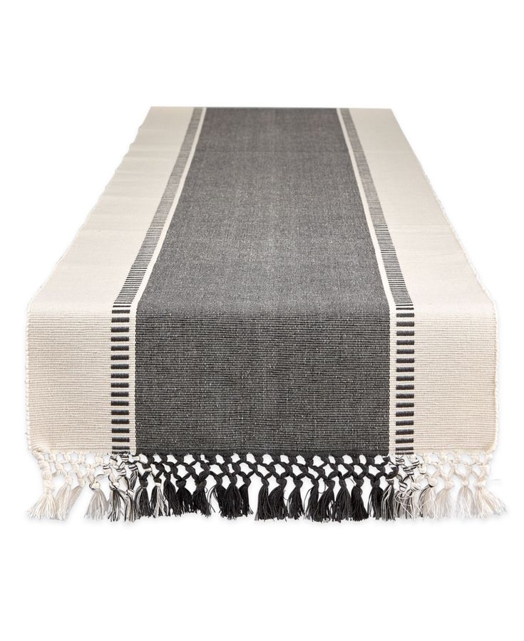 a black and white table runner with tassels