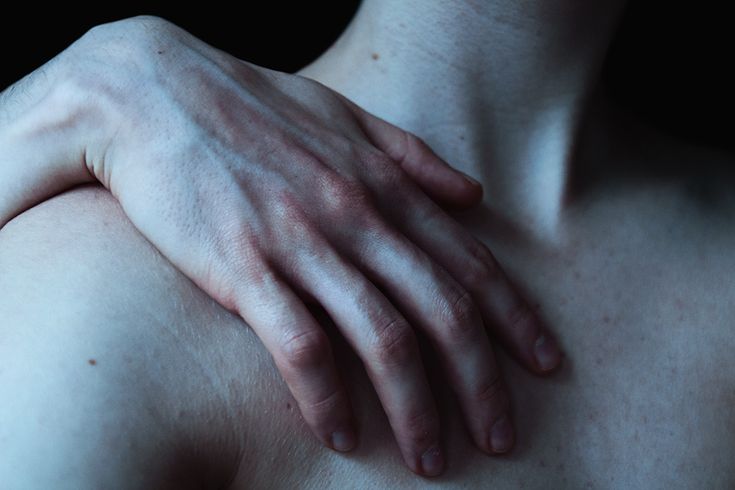 a close up of a person's hand on his chest with no visible skin