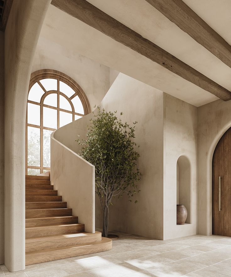 a tree is in the middle of a room with stairs and arched windows on either side