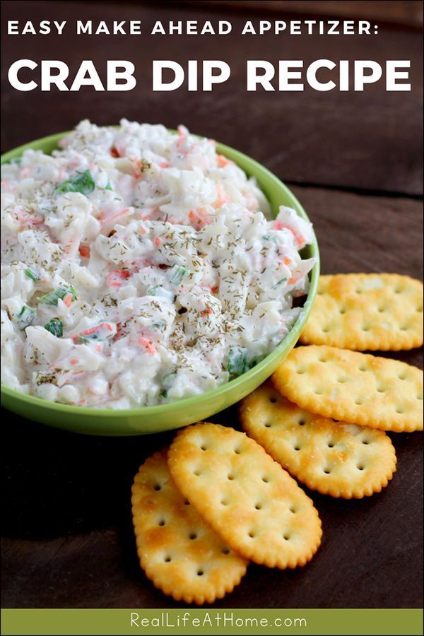 crab dip recipe in a green bowl with crackers on the side and text overlay that reads easy make ahead appetizer crab dip recipe