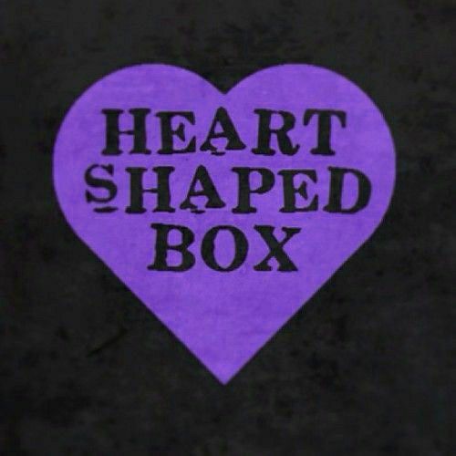 a purple heart shaped box with the words heart shaped box written in black on it