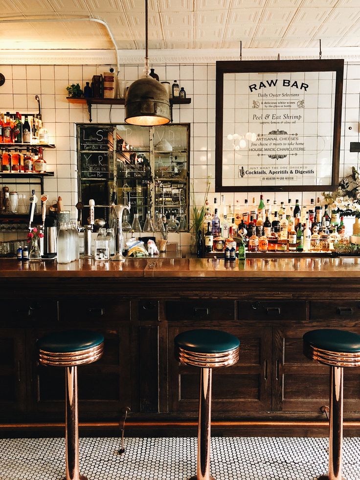 three stools sit in front of the bar