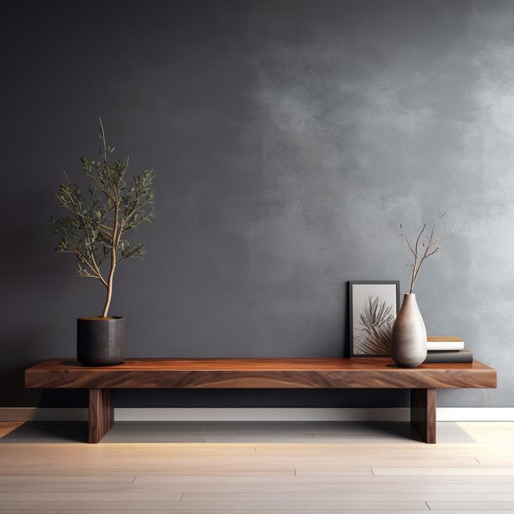 two vases sitting on top of a wooden table in front of a gray wall