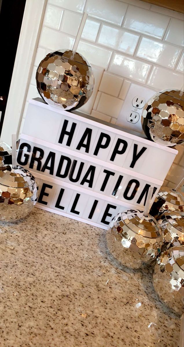 a sign that says happy graduation and some disco balls