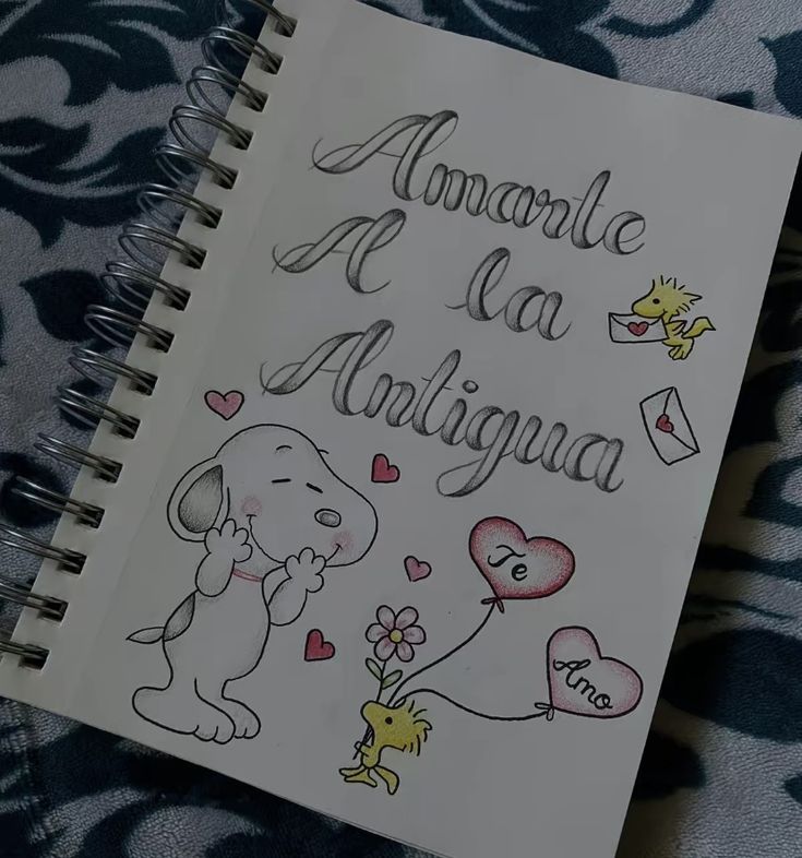 an open notebook with some drawings on the cover and writing in spanish, english or french