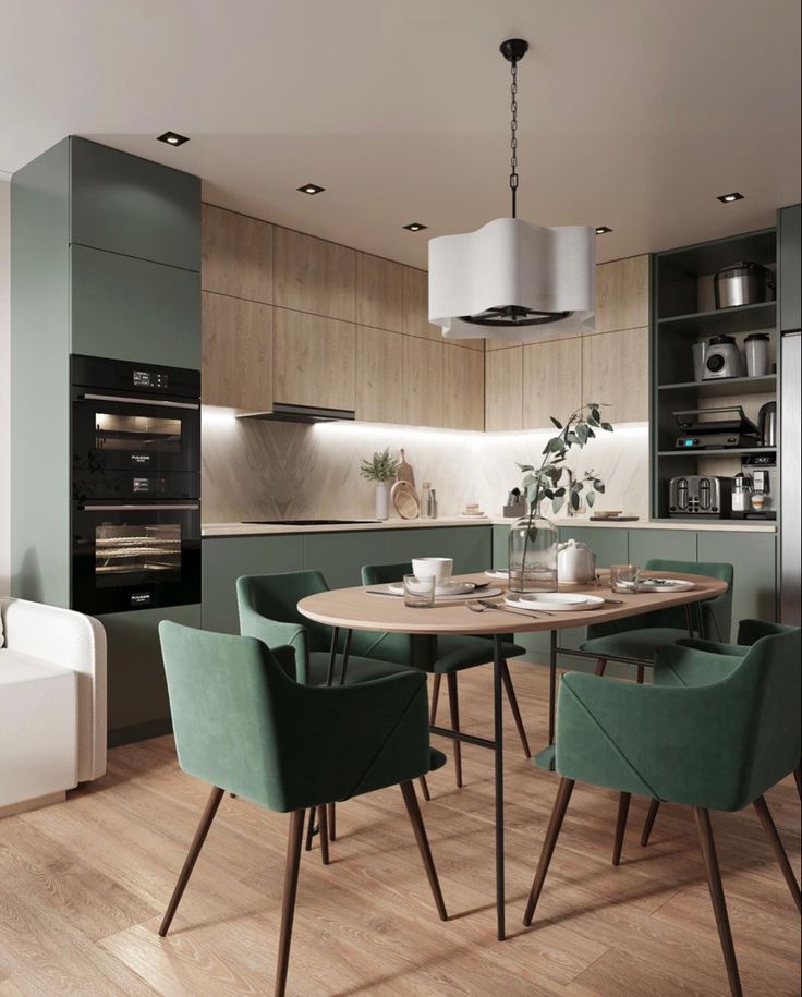 a modern kitchen with green chairs and an oven in the backround, surrounded by wood flooring