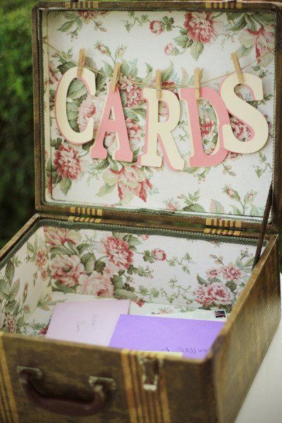 an open suitcase with the word cards in pink and white letters on it's lid