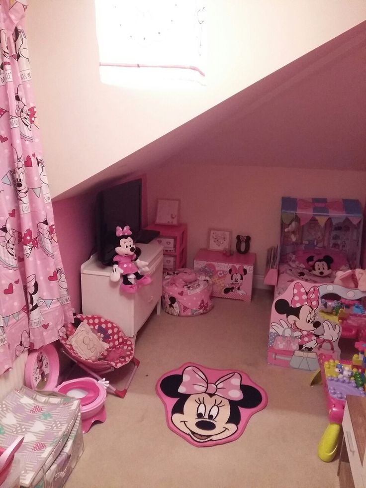 a bedroom with minnie mouse rugs and other items