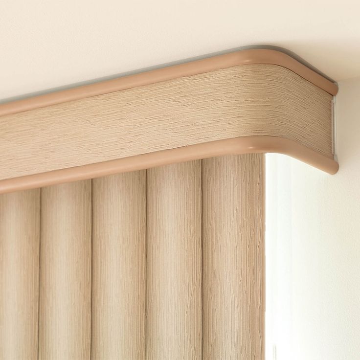 a close up view of the top of a window with wooden blinds in front of it