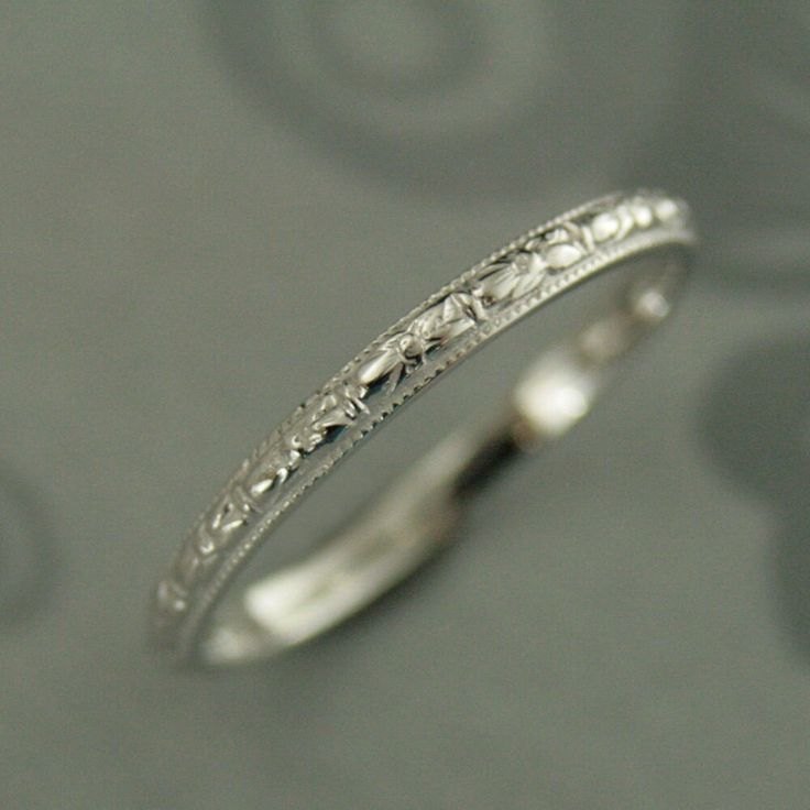 a white gold wedding band with intricate designs