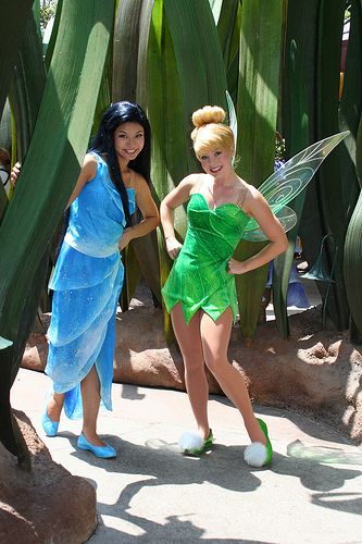 two women dressed as tinkerbells in front of cacti