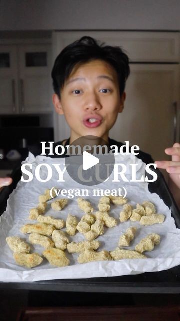 a person holding a tray with food on it and the words, homemade soy curls vegan meat