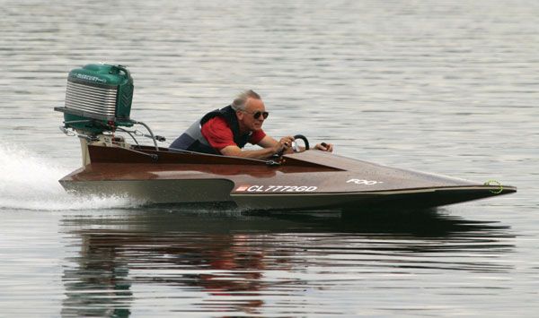 an older man is riding in a speed boat